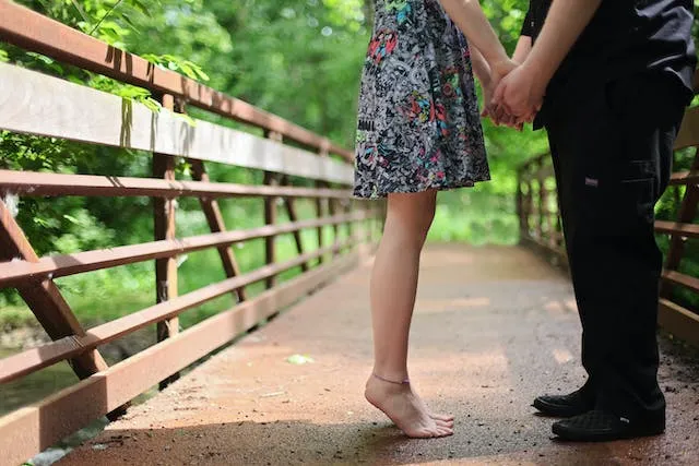 Holding Hands On A Bridge pose for Fall Couple Photoshoot Ideas 1