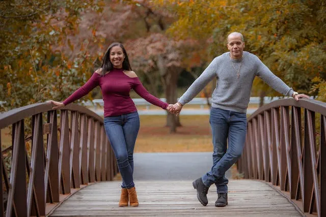 Holding Hands On A Bridge pose for Fall Couple Photoshoot Ideas