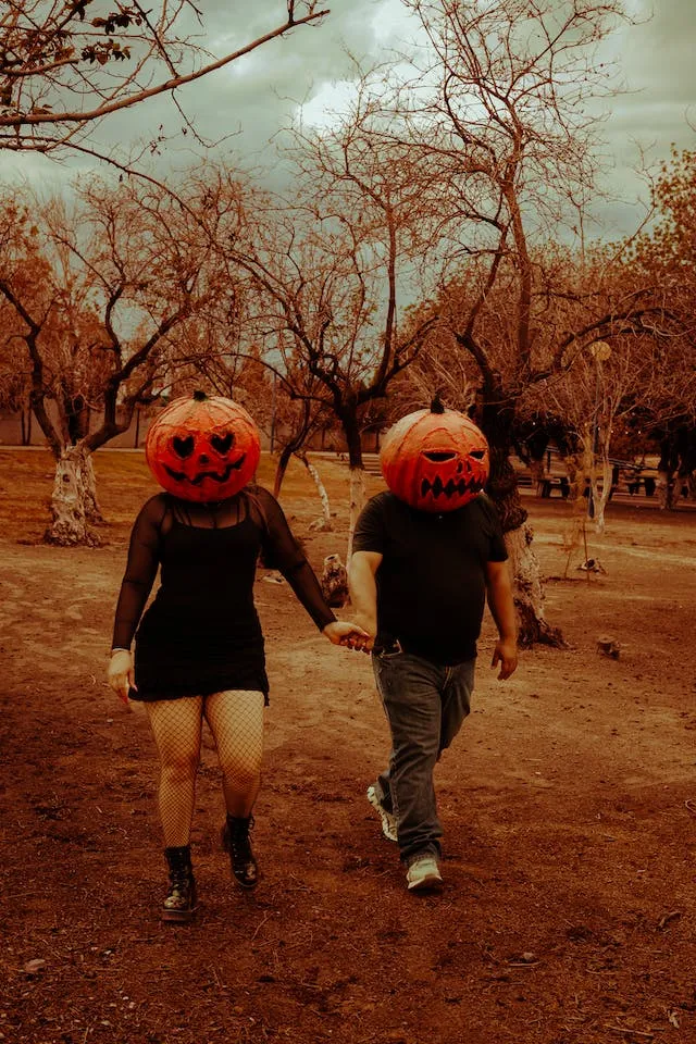 Carved Pumpkins On The Head pose Fall Couple Photoshoot Ideas 2