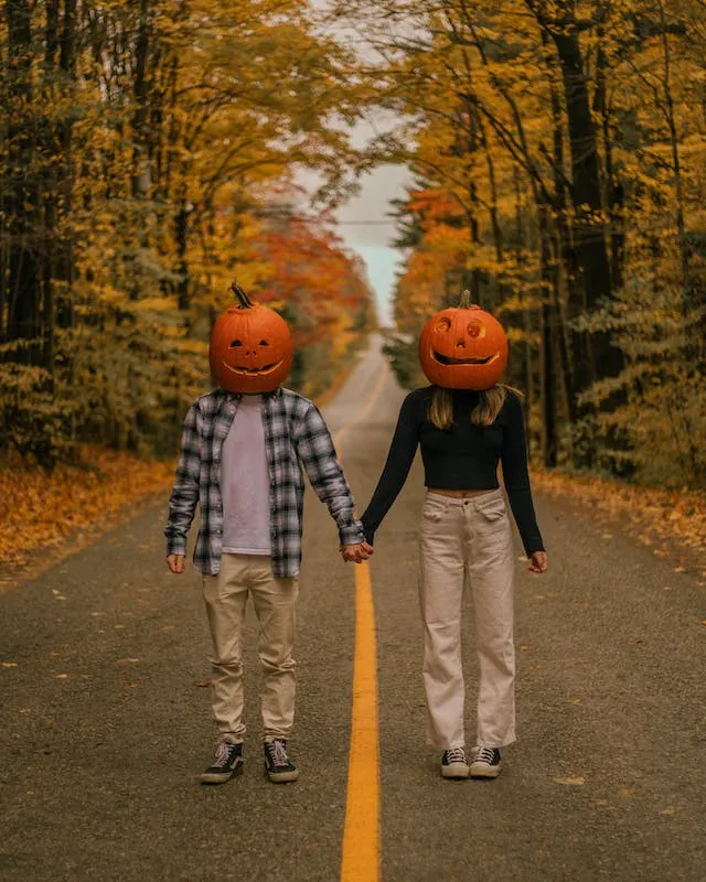 Carved Pumpkins On The Head pose Fall Couple Photoshoot Ideas 3